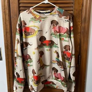 Women’s tan colored sweatshirt with dachshund designs. Size L polyester